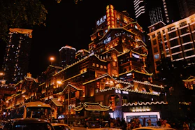 A city street at night with cars and buildings lit up