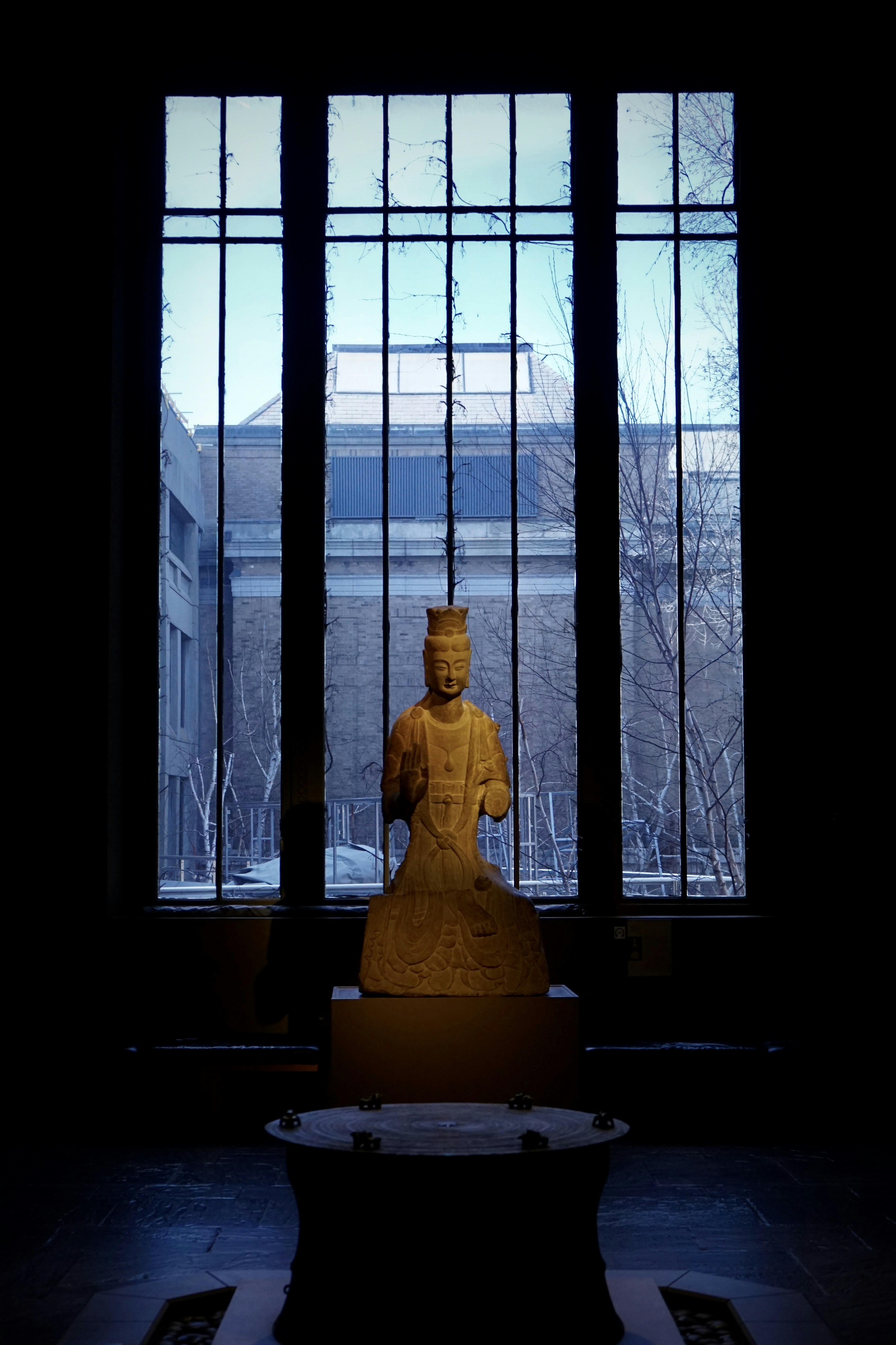 A buddha statue sitting in front of a window photo – Free Boston Image ...