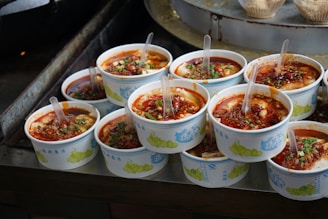 A bunch of bowls of food sitting on a table