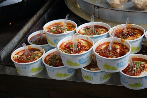 A bunch of bowls of food sitting on a table