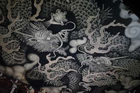 A black and white picture of a dragon on a wall
