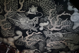 A black and white picture of a dragon on a wall