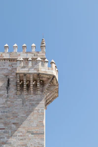A tall brick tower with a clock on it's side