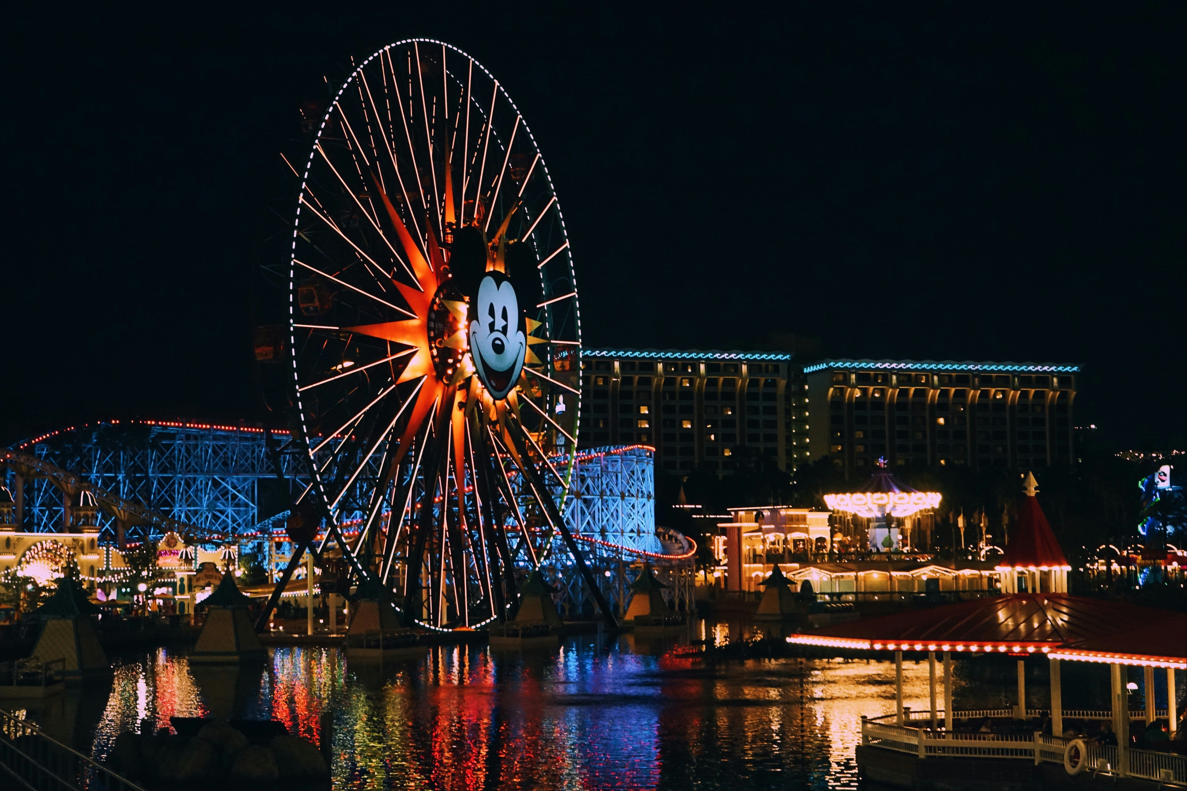 A ferris wheel in the middle of a city at night