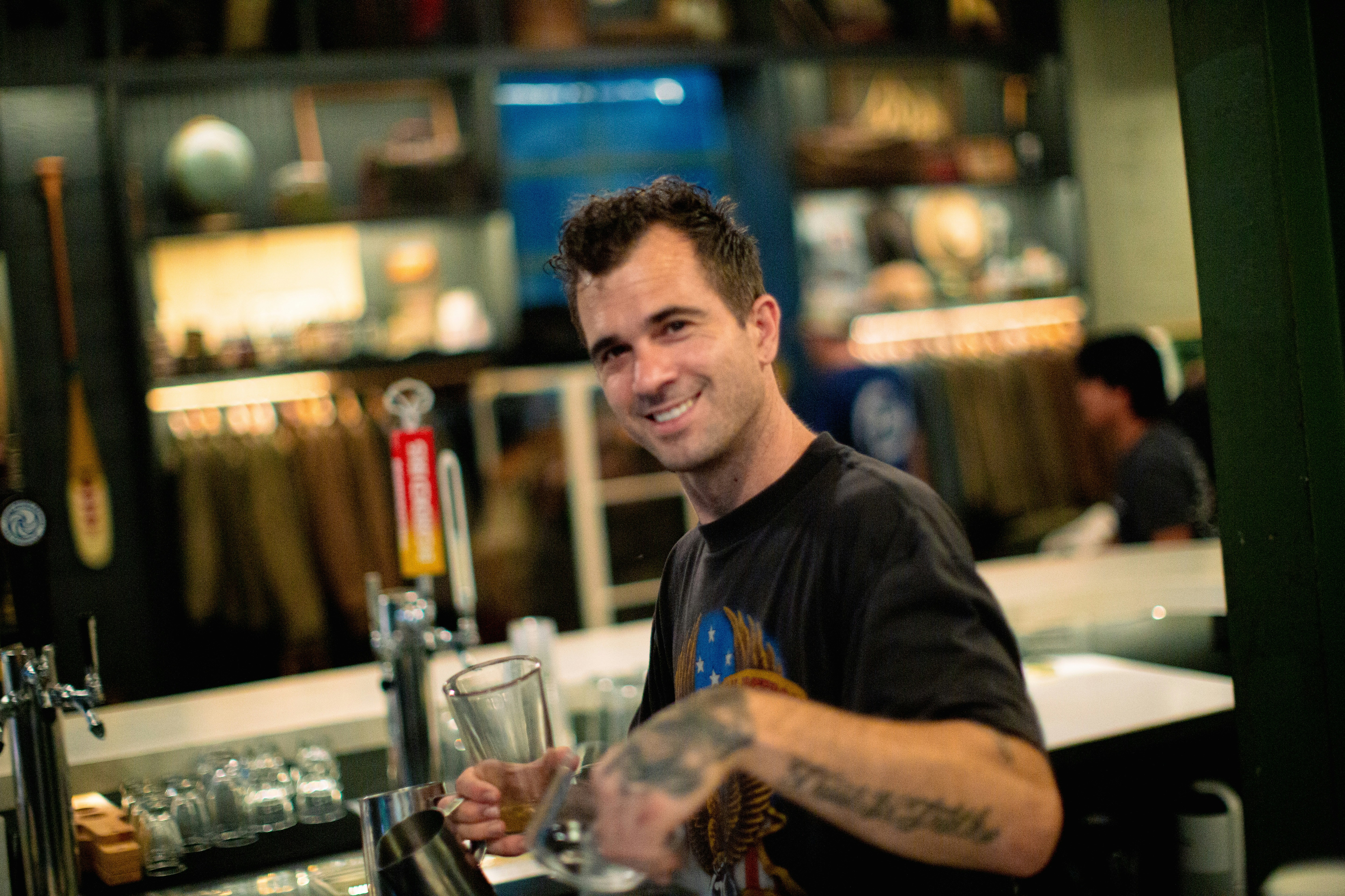 A man sitting at a bar with a glass in his hand