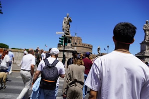 A group of people walking across a street