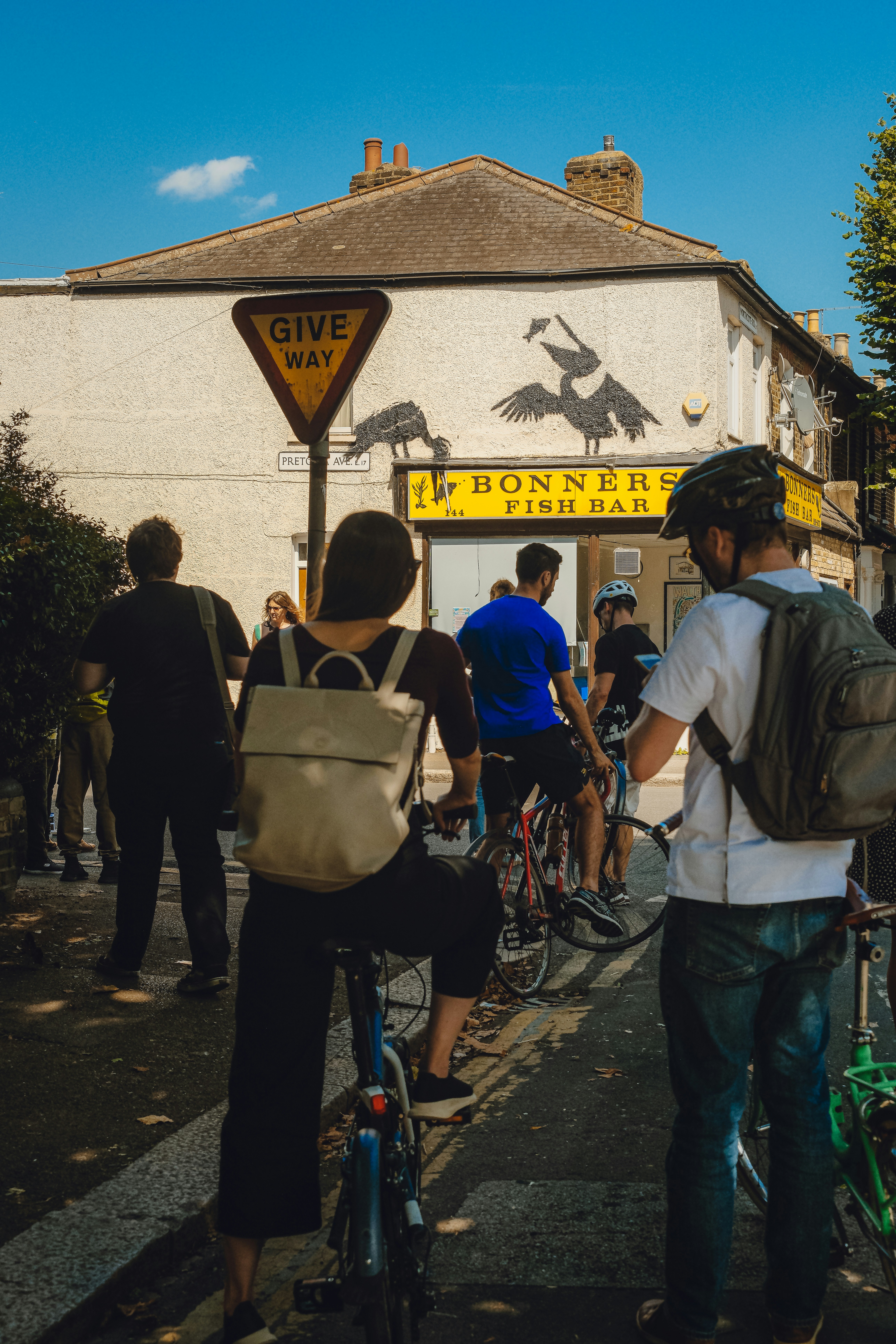 A group of people riding bikes down a street