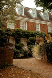 A large brick building with ivy growing on it's sides