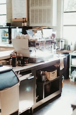 A kitchen with a lot of clutter on the counter