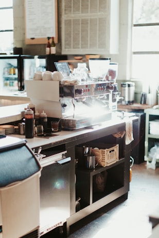 A kitchen with a lot of clutter on the counter
