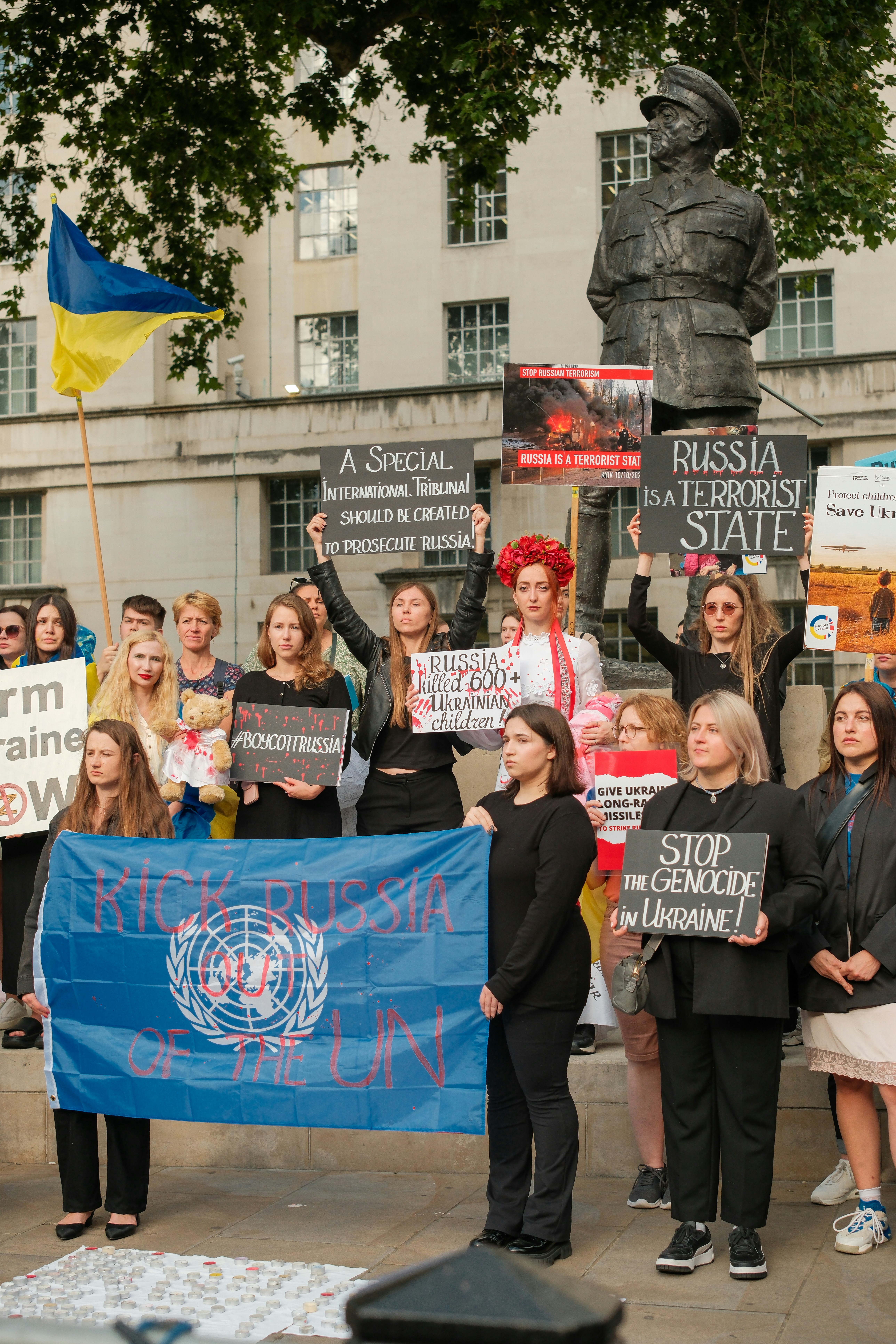 A group of people holding up signs in front of a building