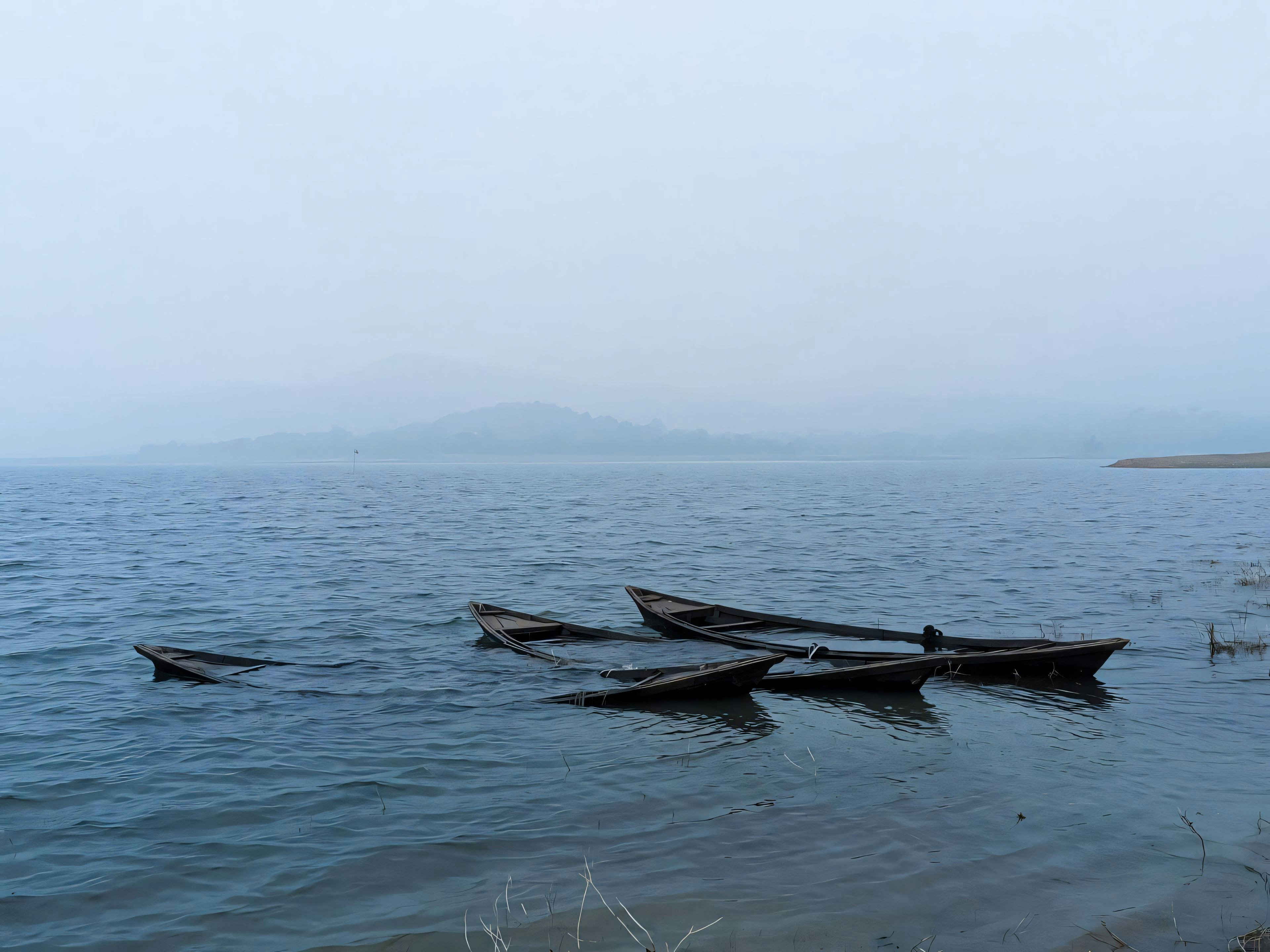 A group of boats floating on top of a body of water