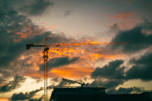 Tower crane on a construction site at sunset