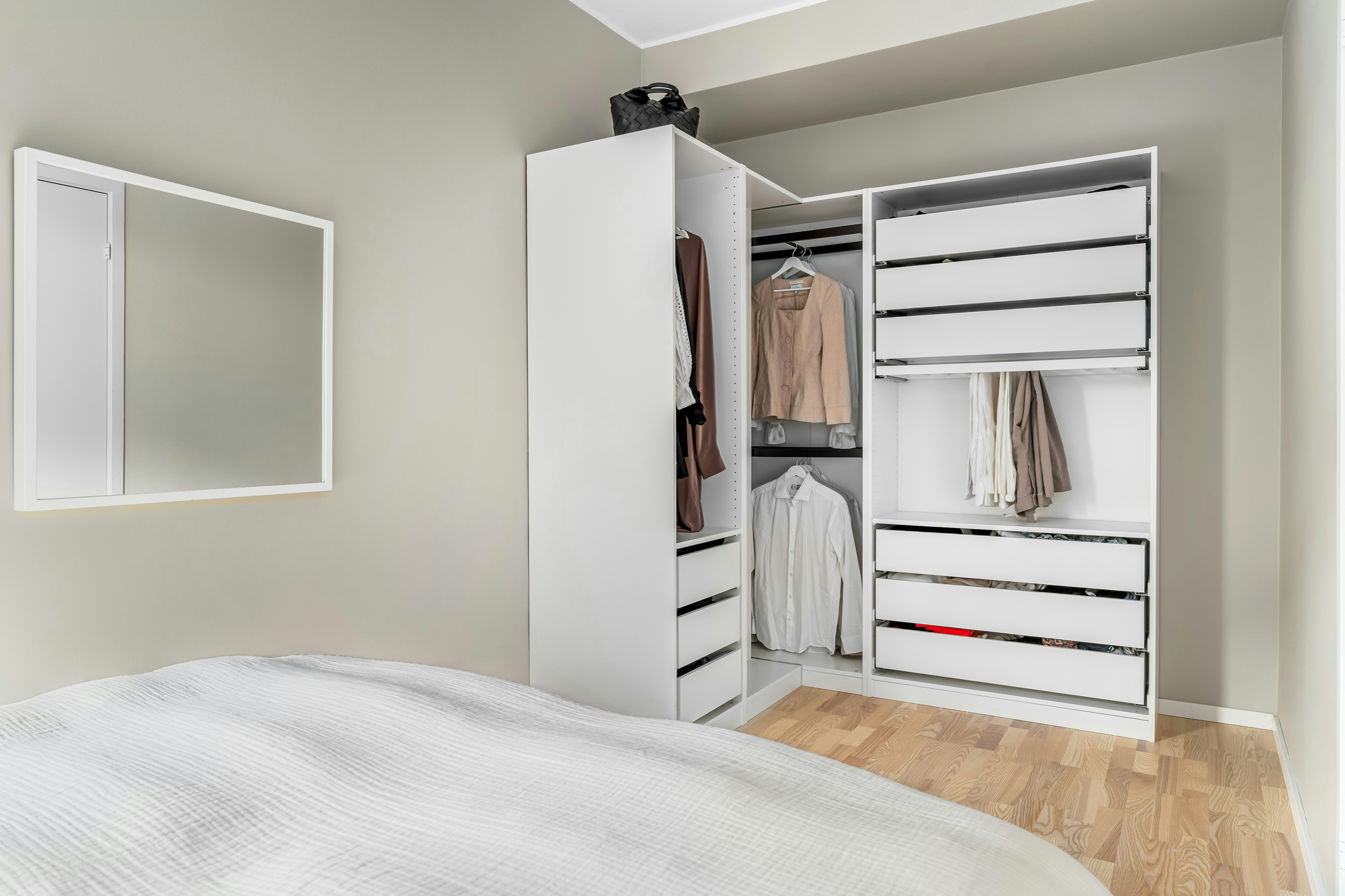 Ikea PAX wardrobe integrated with other storage solutions in a modern bedroom