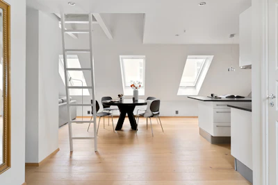 A room with a ladder and a table in it