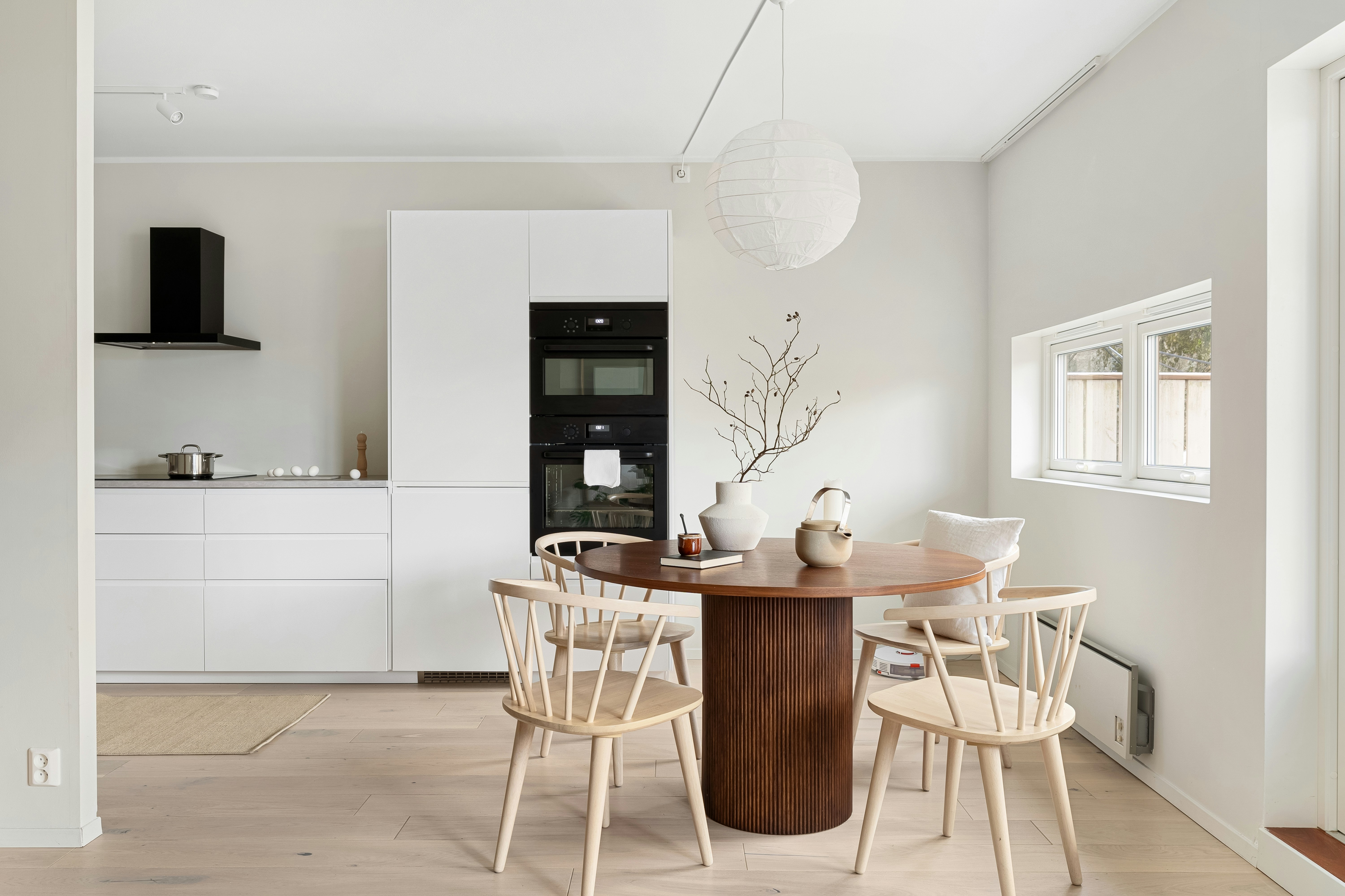 A dining room with a table and chairs