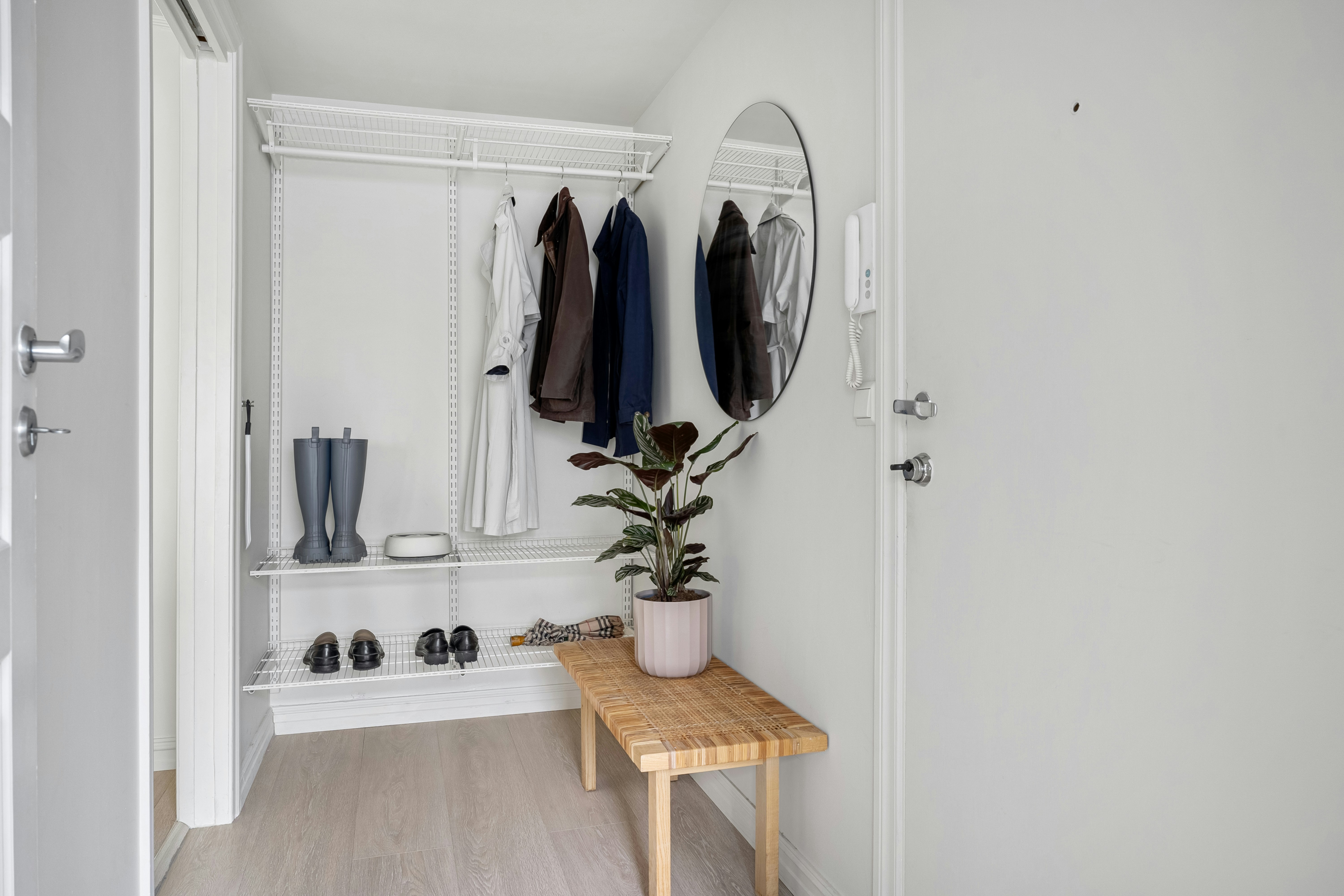 walk-in closet featuring a small vanity, a stylish chair, and decorative elements - apartments with walk in closets
