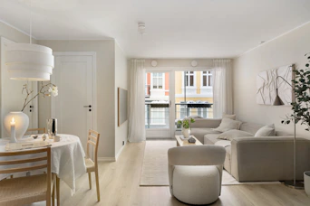 A living room filled with furniture and a dining room table