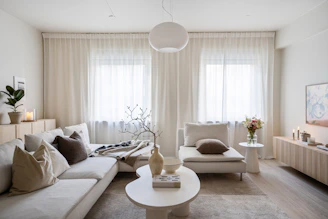 A living room filled with furniture and a large window