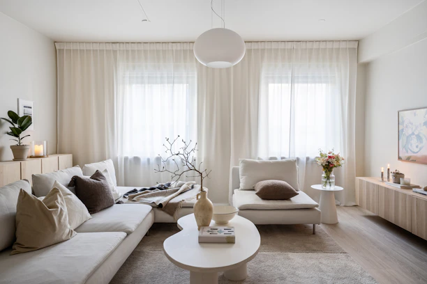 A living room filled with furniture and a large window