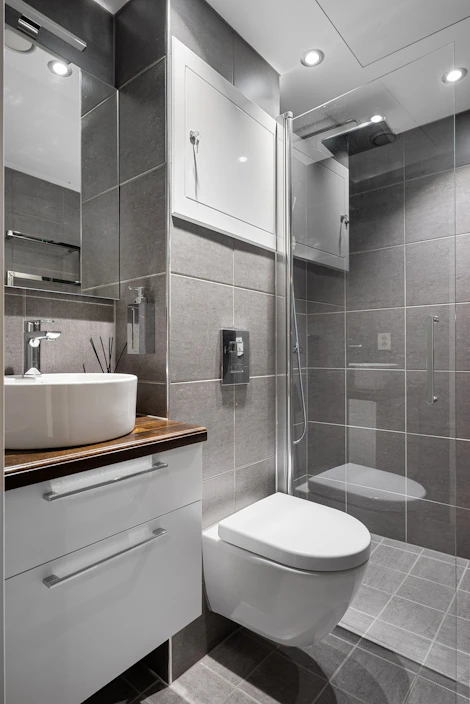 A white toilet sitting next to a white sink