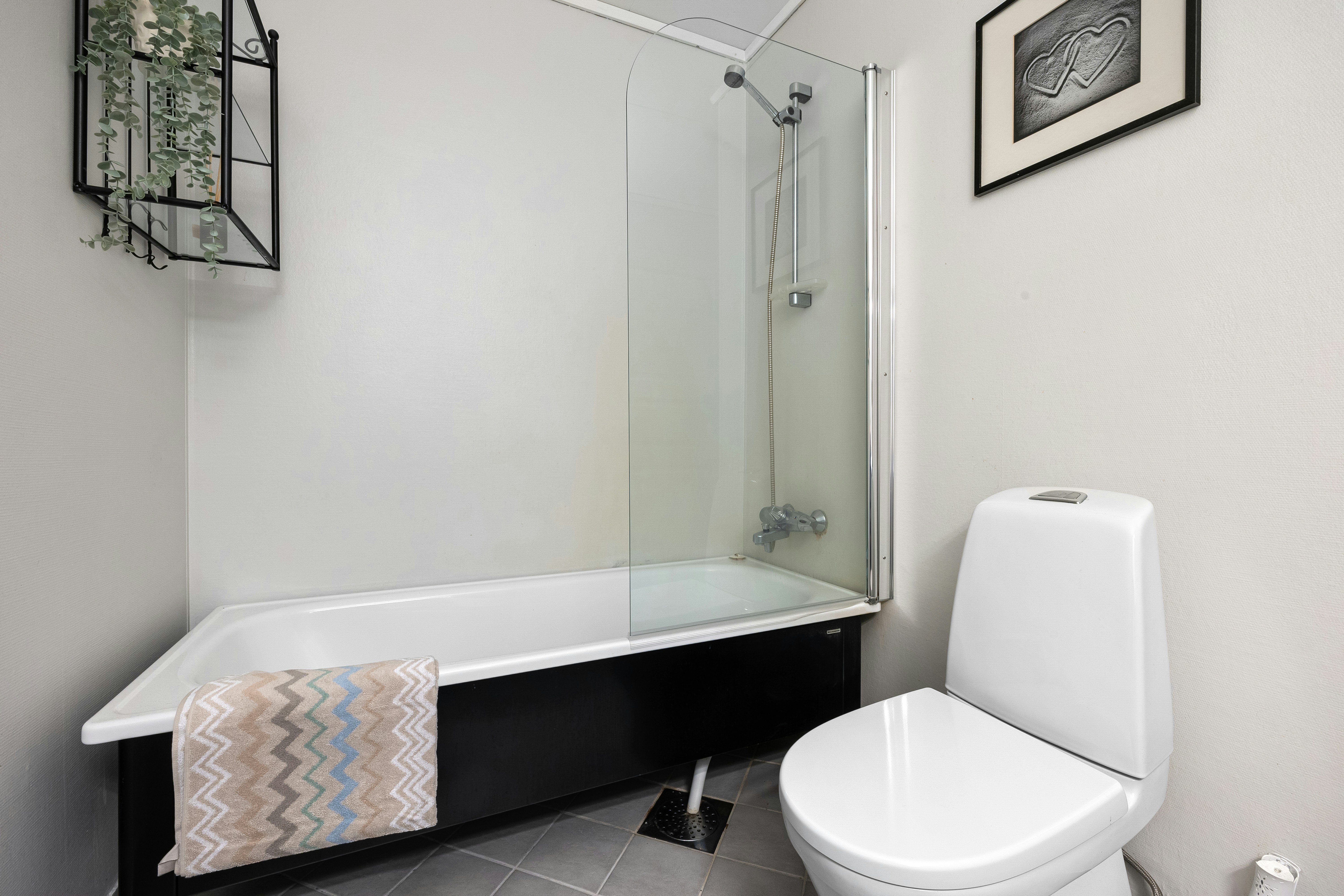 Spacious modern bathroom with freestanding tub and pastel tones