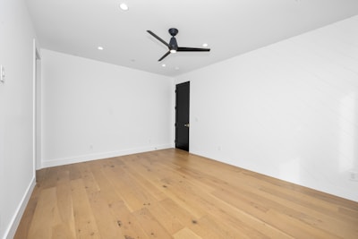 An empty room with a ceiling fan in it