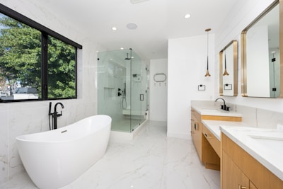 A large white bathroom with a large tub