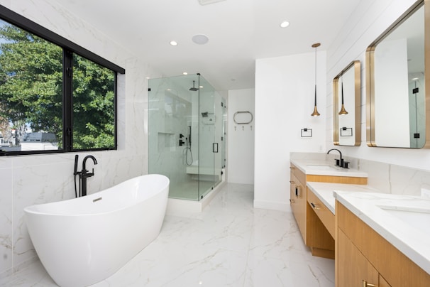 A large white bathroom with a large tub