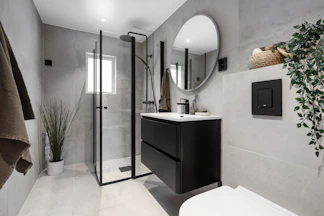 A bathroom with a toilet, sink, and shower