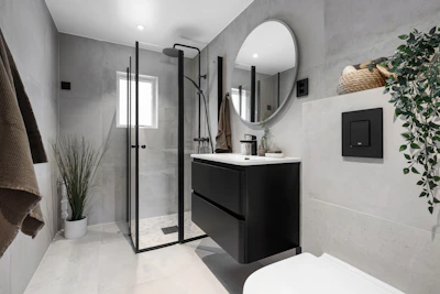 A bathroom with a toilet, sink, and shower