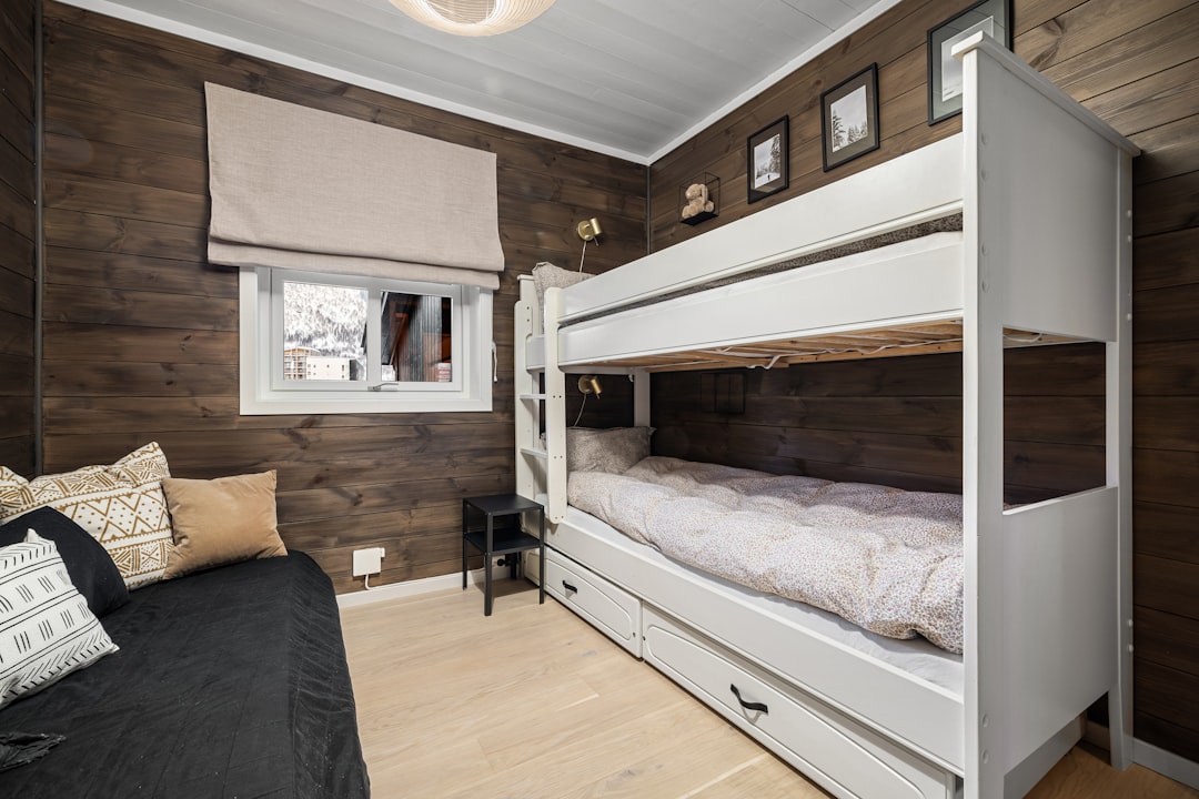 A bedroom with bunk beds and a couch,