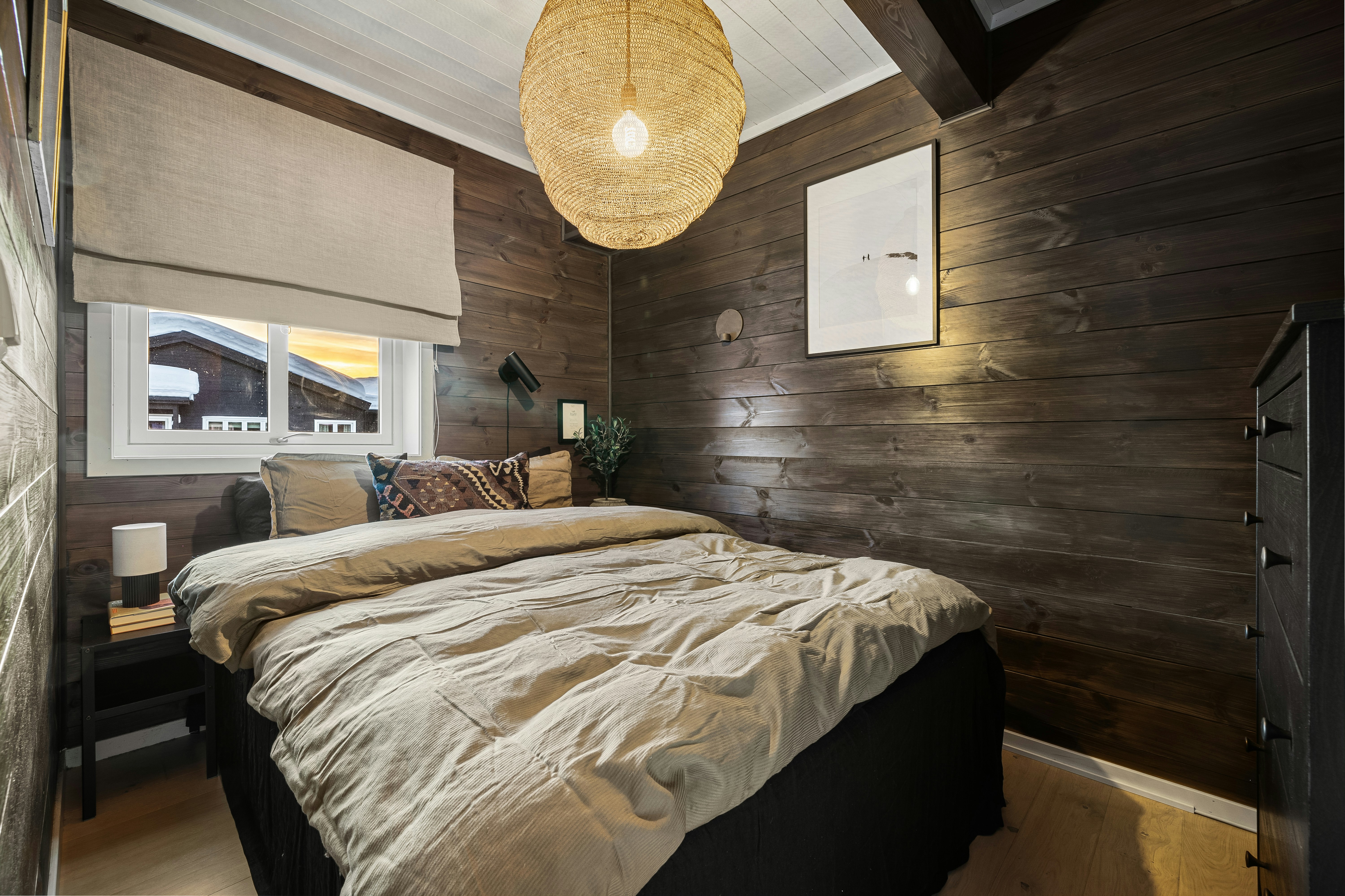A bedroom with a large bed and wooden walls