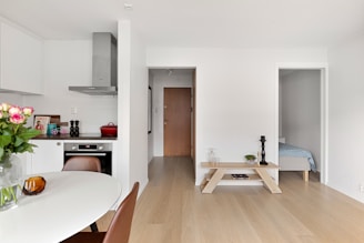 A kitchen with a table and chairs in it