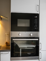 A black and silver oven and microwave in a kitchen