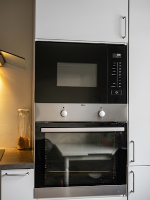 A black and silver oven and microwave in a kitchen