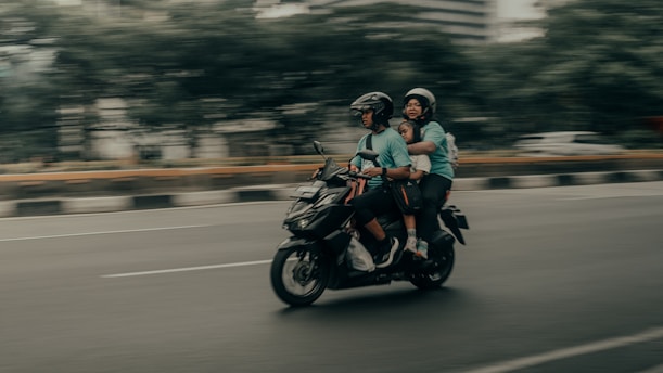 A couple of people riding on the back of a motorcycle
