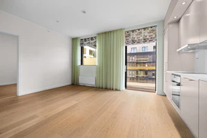 Empty room with a wooden floor and green curtains
