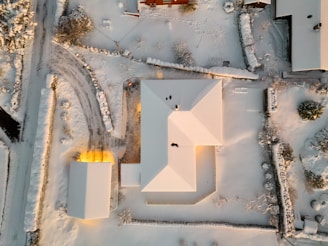 An aerial view of a house in the snow