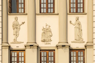 A tall building with statues on the side of it