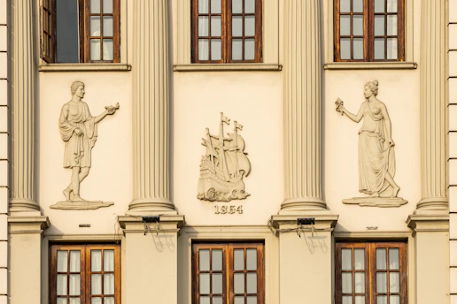 A tall building with statues on the side of it