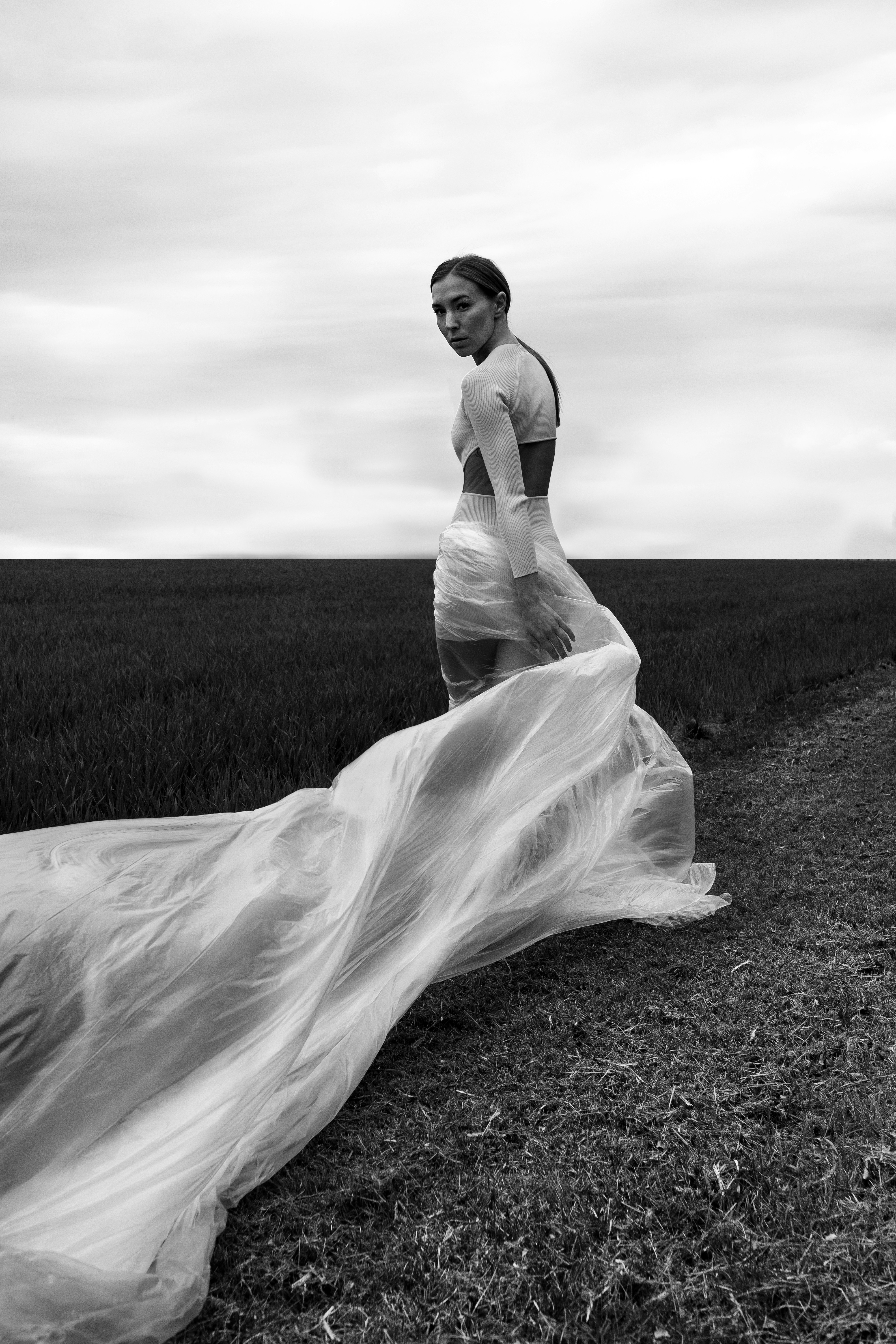 A black and white photo of a woman in a dress