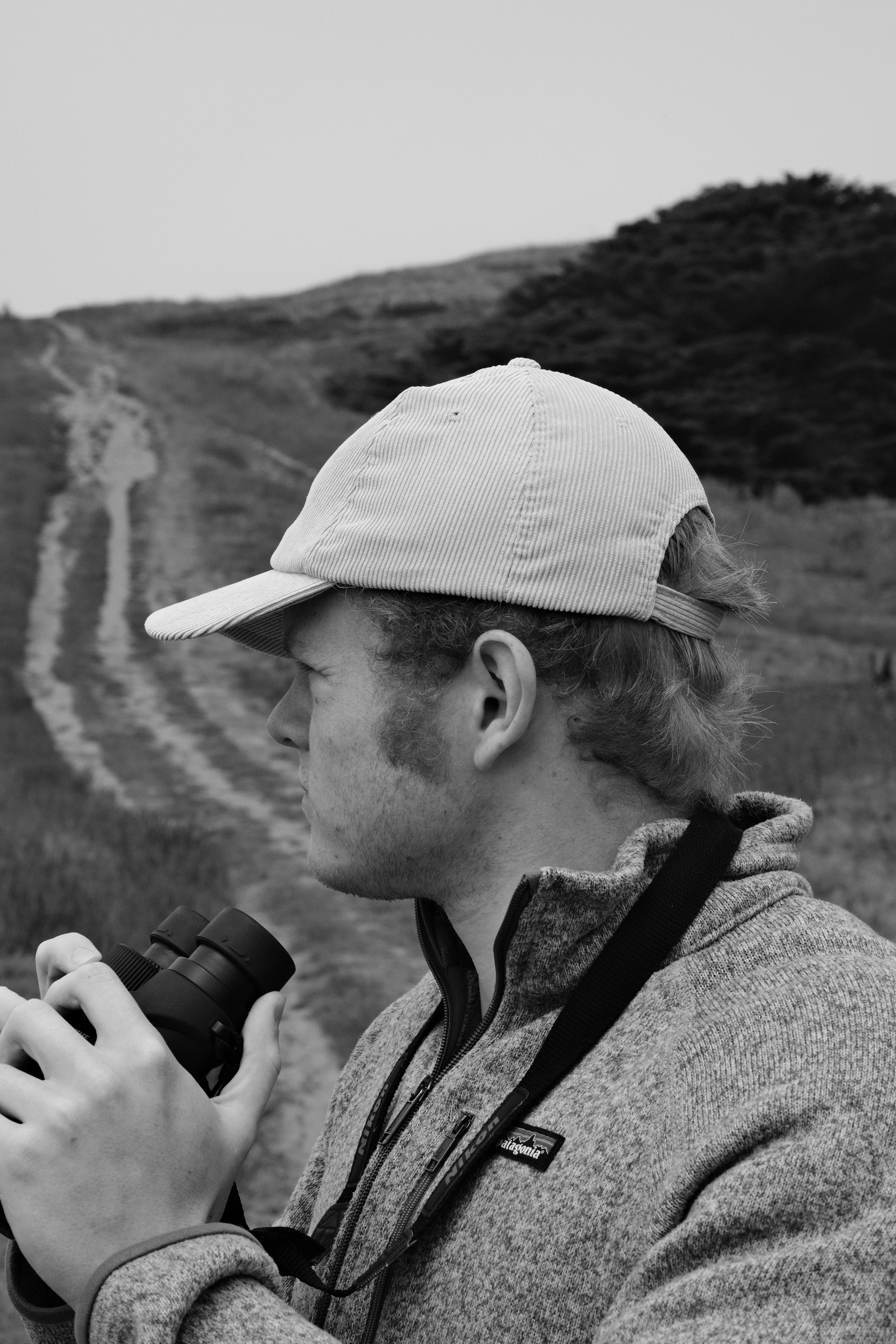 A man with a hat and a camera