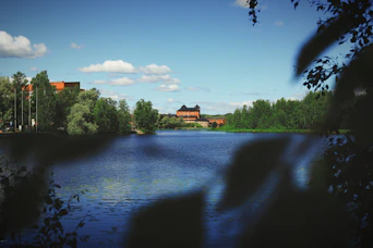 A body of water surrounded by trees and buildings
