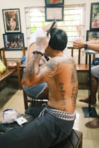 A man getting his hair cut at a barber shop