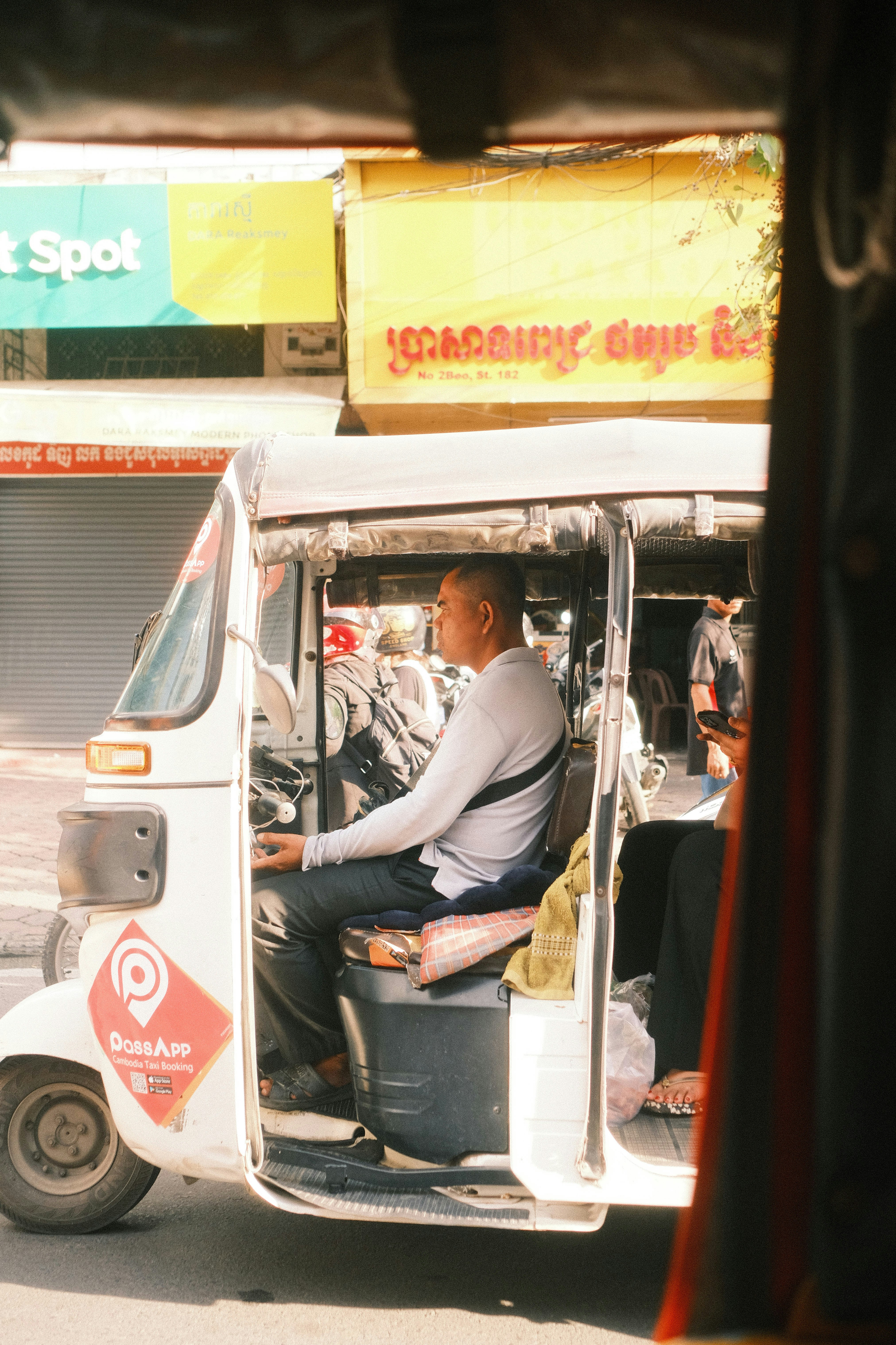 A man sitting on the back of a white bus