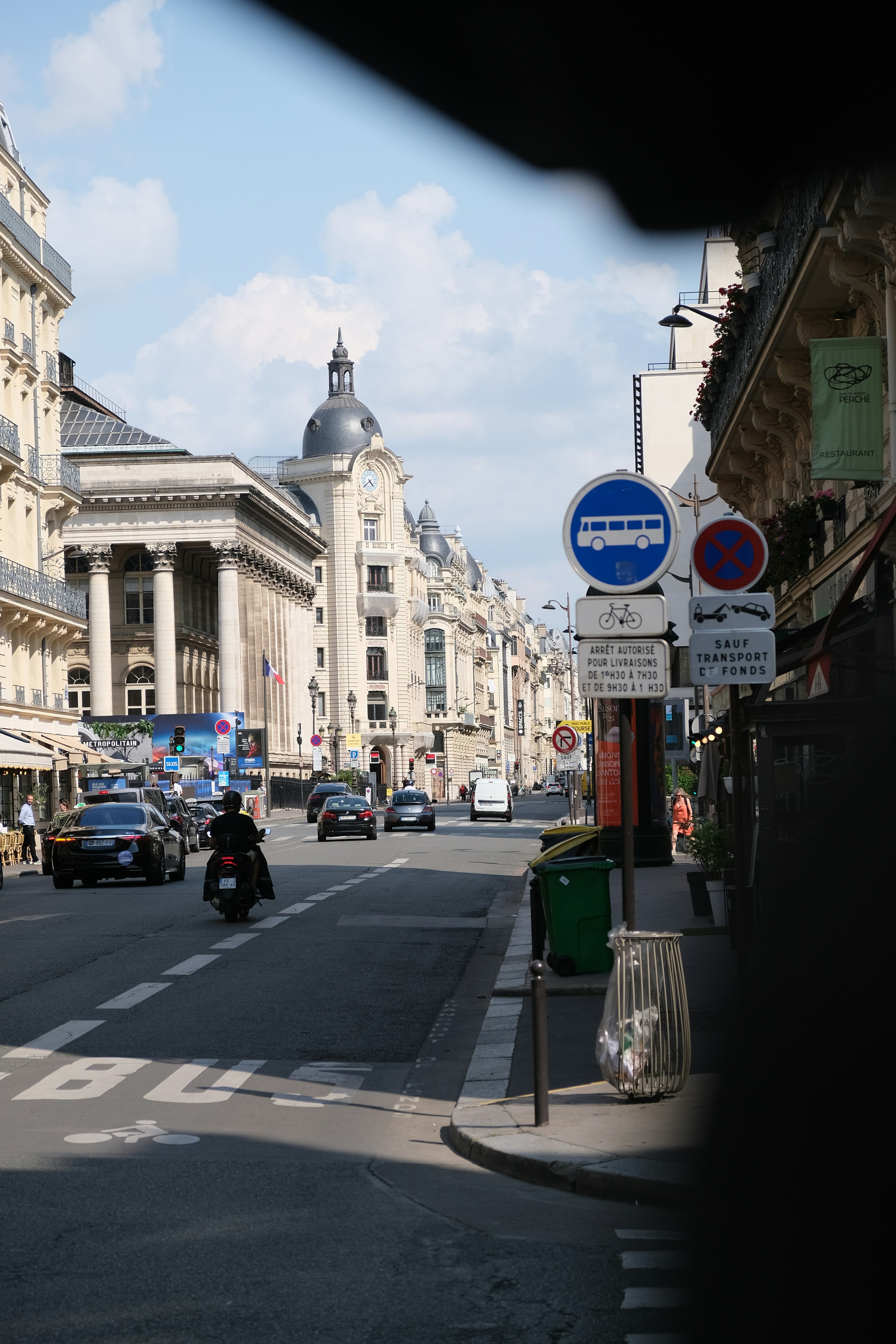 A city street filled with lots of tall buildings