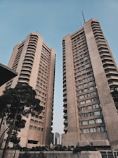A couple of tall buildings sitting next to each other