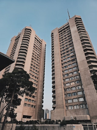 A couple of tall buildings sitting next to each other