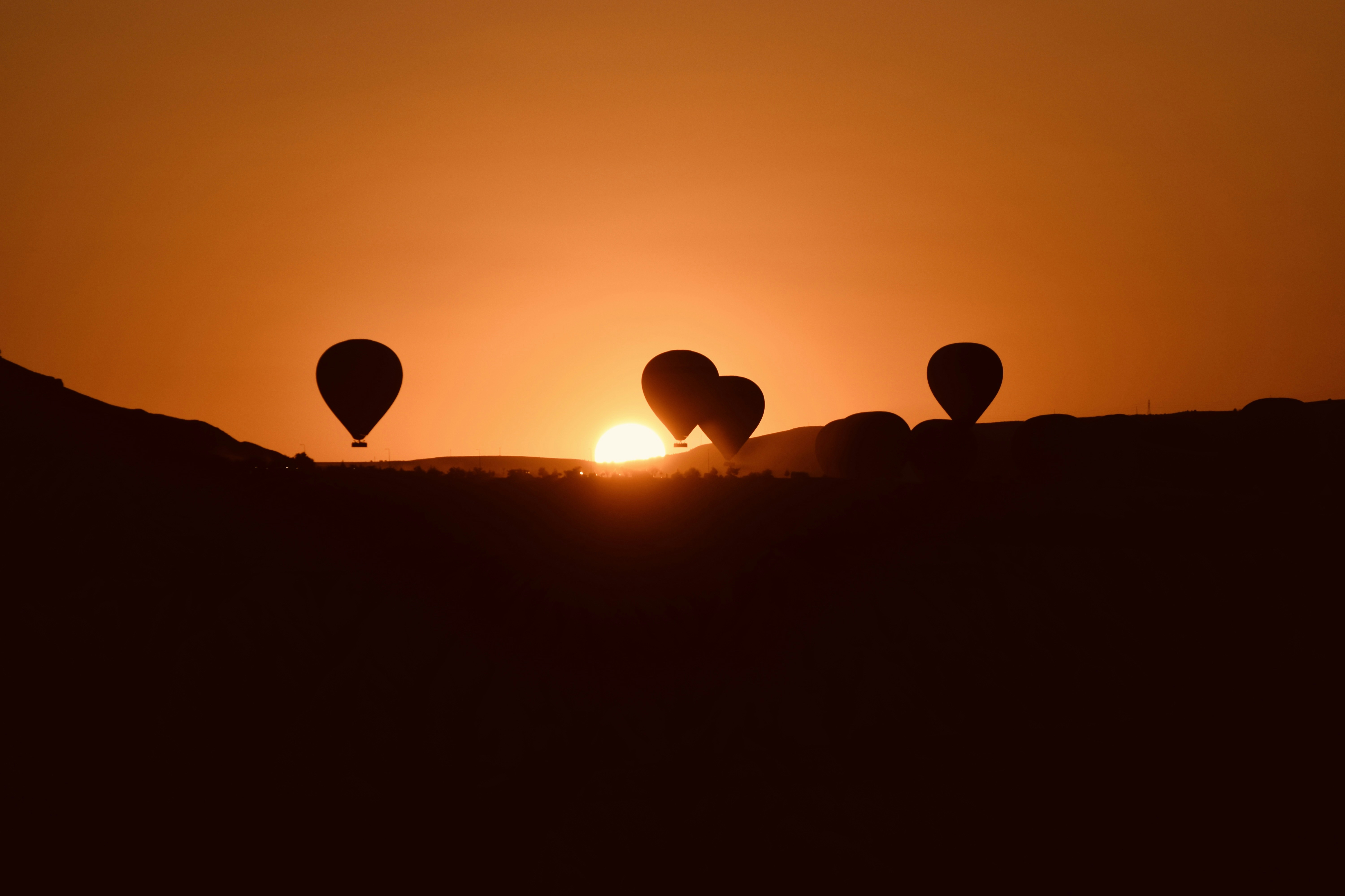 A group of hot air balloons flying in the sky